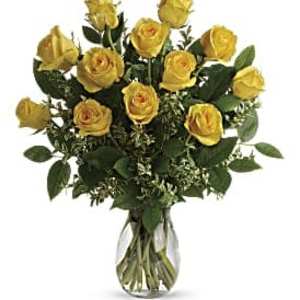 Arrangement of yellow roses in a clear glass vase