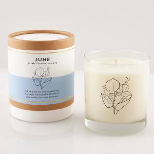 Two June birth flower candles, one in a box and one in a glass jar
