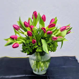 Pink tulips arranged in a clear glass vase