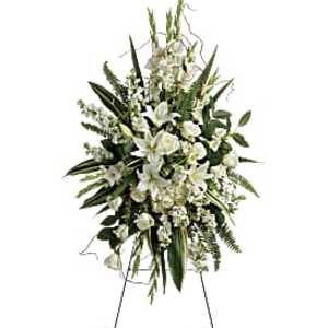 Tall white floral standing spray on a metal easel