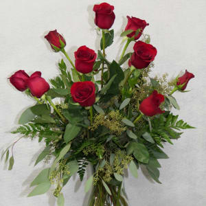 Red roses arranged in a clear glass vase