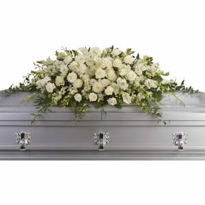 Long white rose and calla lily casket spray on a silver casket