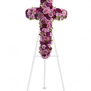 Purple and pink floral cross on a white easel