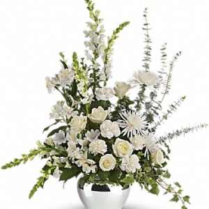 White floral arrangement in a white vase with tall spiky stems