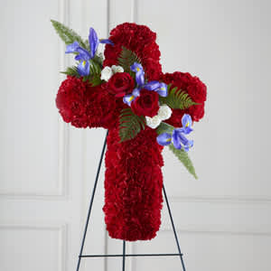 Red floral cross on a black stand with blue and white accents