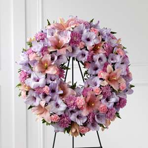 Pastel floral wreath on a black stand