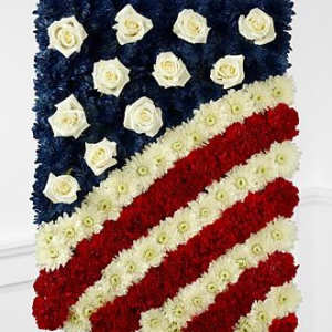 American flag floral tribute with red, white, and blue flowers