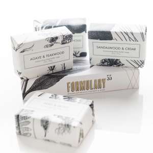Stacked bars of packaged soap in black-and-white boxes