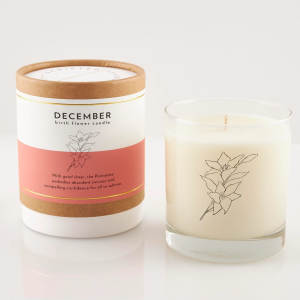 Two December birth flower candles, one in a box and one in a glass jar