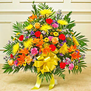 Large mixed flower arrangement with a yellow ribbon bow