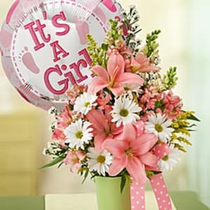 Pink and white flower arrangement with a "It's A Girl" balloon
