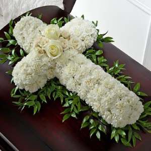 White floral casket spray with roses and greenery