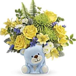 Yellow and white flower arrangement with blue accents in a light blue ceramic teddy bear vase