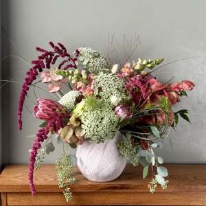 Mixed bouquet in a white vase with pink and white blooms