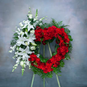 Two floral funeral wreaths, one red and one white, on easels