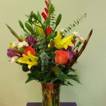 Colorful mixed bouquet in a clear glass vase