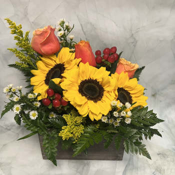 Sunflowers and peach roses in a rectangular wooden box