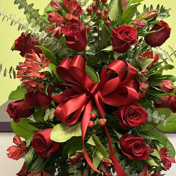 Red rose and alstroemeria arrangement with a large red ribbon