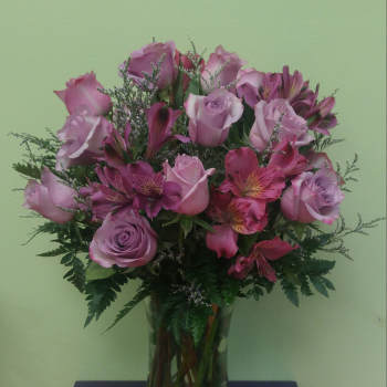 Pink roses and alstroemeria in a clear glass vase