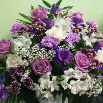 Bouquet of purple and white roses with mixed purple flowers