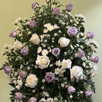Standing floral spray with lavender and white roses and small white daisies