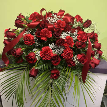Large red rose and carnation arrangement with ribbon and baby's breath