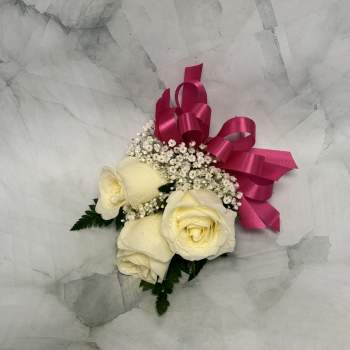 Cream roses with baby's breath and a pink ribbon bow