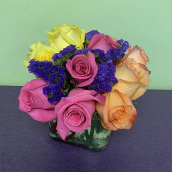 Colorful rose bouquet in a square glass vase