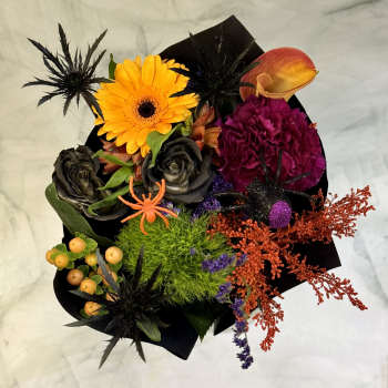 Halloween bouquet with orange gerbera, black roses, and a calla lily