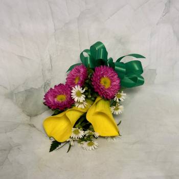 Bouquet with yellow calla lilies, pink daisies, and white daisies tied with green ribbon