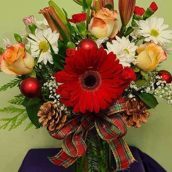 Red gerbera bouquet with white daisies, peach roses, and ribbon in a glass vase