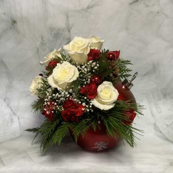 White roses and red carnations arranged in a red ornament-shaped vase