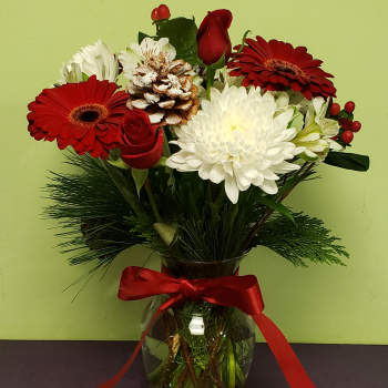 Red and white mixed bouquet in a glass vase with a red ribbon