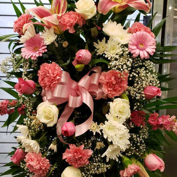 Standing floral spray with pink lilies, roses, and carnations