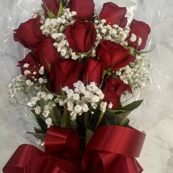 Bouquet of red roses with white baby's breath and a red ribbon