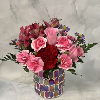 Pink and red mixed bouquet in a colorful mosaic vase