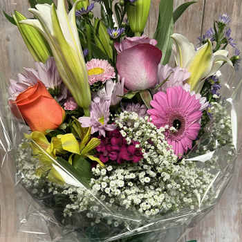 Mixed bouquet with lilies, roses, gerbera daisies, and purple filler flowers