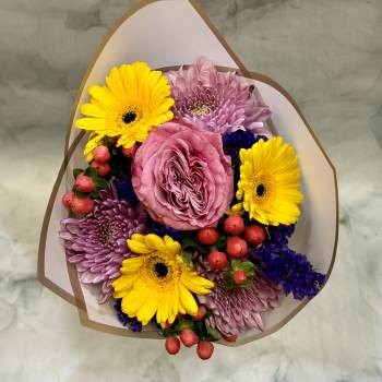 Bouquet of pink roses, yellow gerbera daisies, and purple chrysanthemums