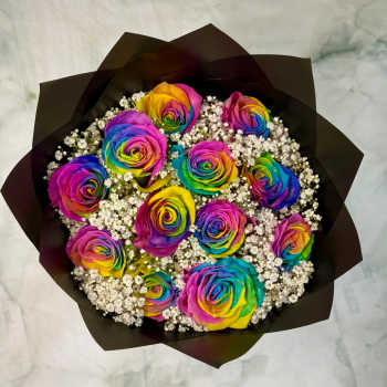 Bouquet of rainbow-colored roses with white filler flowers