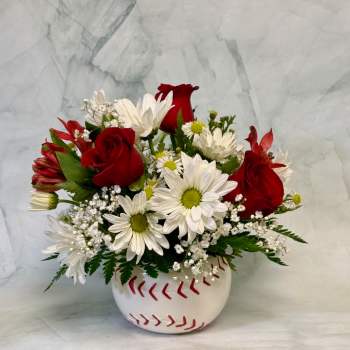 Red roses and white daisies in a baseball-shaped vase
