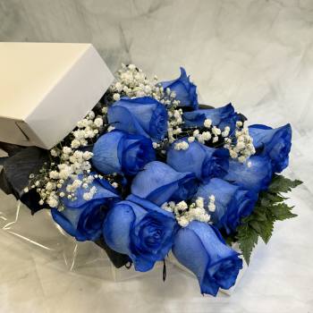 Bouquet of blue roses with white baby's breath in a box