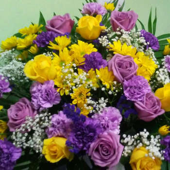 Bouquet of yellow and purple flowers with lavender roses