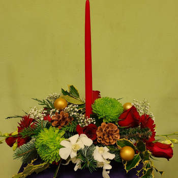 Holiday centerpiece with red candle, red roses, green mums, and white orchids