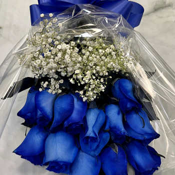 Bouquet of blue roses with white baby's breath wrapped in clear plastic