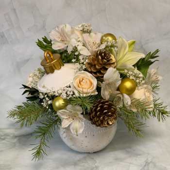 White floral arrangement with lilies, roses, pinecones, and gold ornaments in a ceramic vase