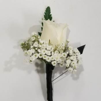 White rose boutonniere with baby's breath and dark greenery