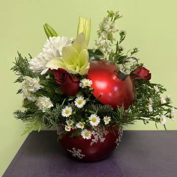 Red ornament vase arrangement with white flowers and greenery