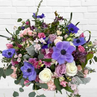 Mixed bouquet with purple anemones and pink and white roses