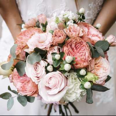 Pink and peach bridal bouquet with white accents and eucalyptus