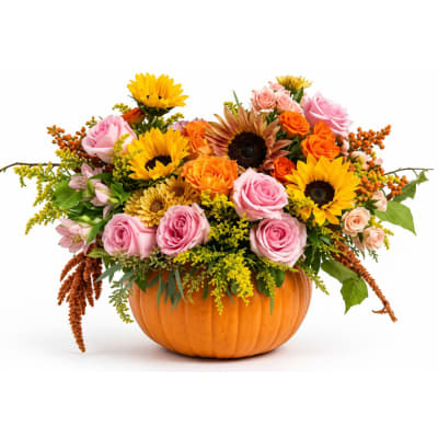 Mixed bouquet in a pumpkin-shaped container with roses and sunflowers